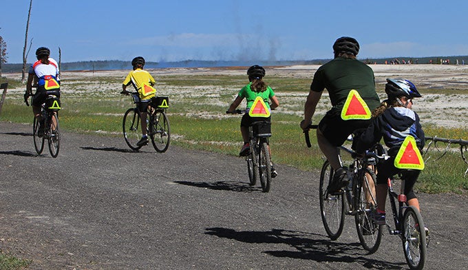 YS-Biking-Fountain-Freight-Road-family_NPSJimPeaco_680 A family riding bikes on the Fountain Freight Road behind the Grand Prismatic Spring. Photo by NPS Jim Peaco