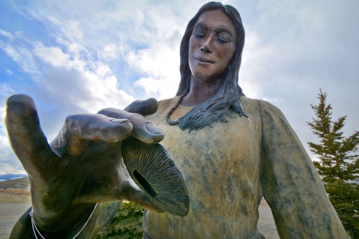 A bronze statue of Sacajawea holding a sand dollar at the Sacajawea Cemetery on the Wind River Reservation in Wyoming