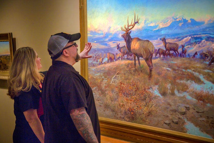 Museum visitors view a painting by C.M. Russell in Great Falls, Montana