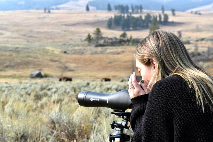 RoamYSGuiding-SpottingScope-woman_Toddchlotfeldt_courtesy_700 Viewing Yellowstone wildlife with a spotting scope