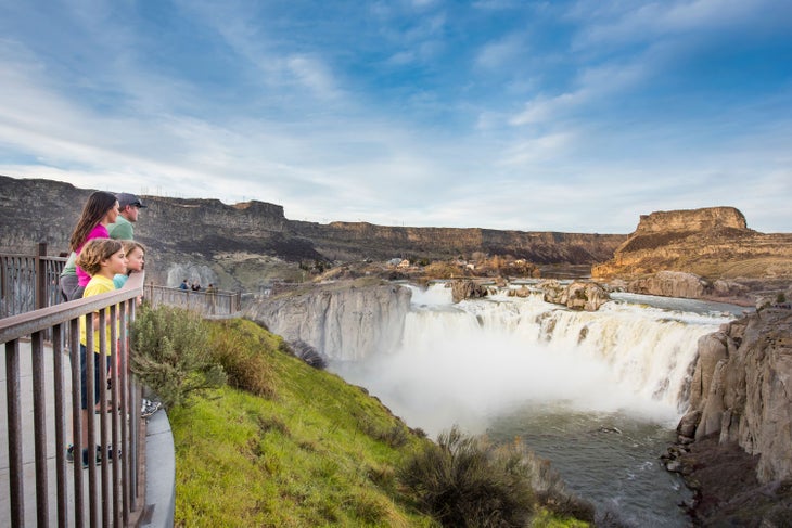Family viewing Shoshone Falls from the lookout during spring run-off. Twin Falls, Idaho.