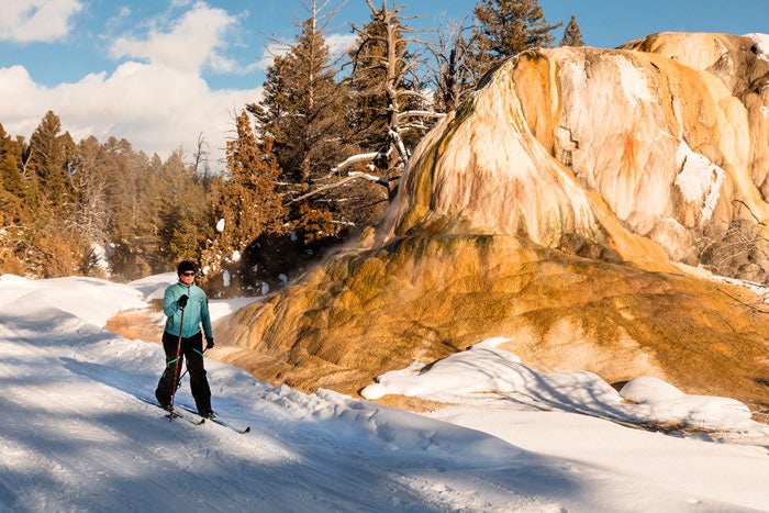 YS-xcountry-skier-orangespringmound_NPSJacobWFrank_700 A cross-country skier at Orange Spring Mound on the Upper Terrance of Mammoth Hot Springs in Yellowstone
