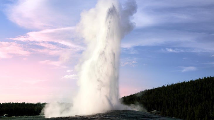 Old Faithful Geyser in the evening sunset