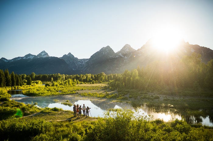 Wildlife watchers using a spotting scope at a safe distance in Grand Teton National Park