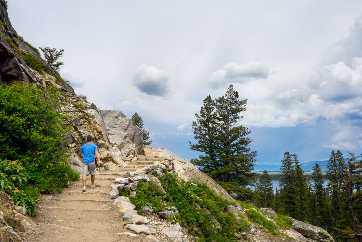 Man hiking Cascade Canyon Trail to Inspiration Point from Jenny Lake