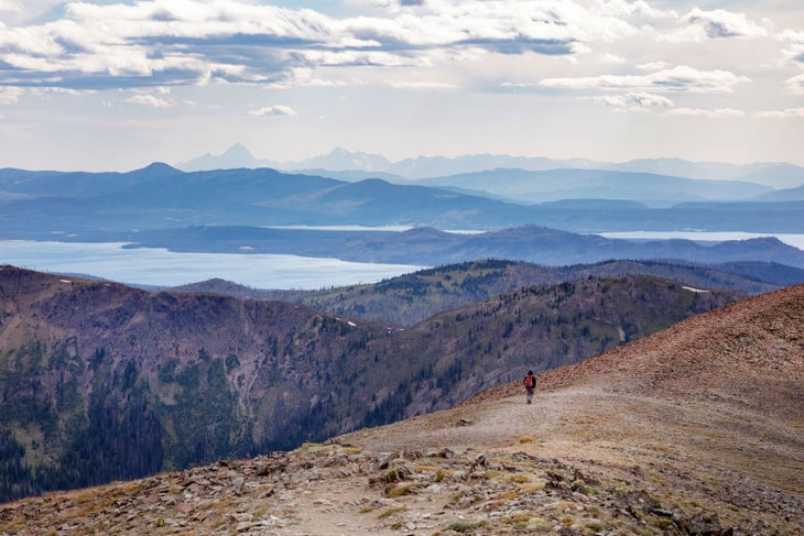 Hiking Avalanche Peak Trail with a Teton Mountain Range view in the far distance.