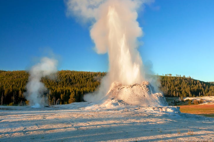 Castle Geyser erupting in early evening in Yellowstone's Upper Geyser Basin