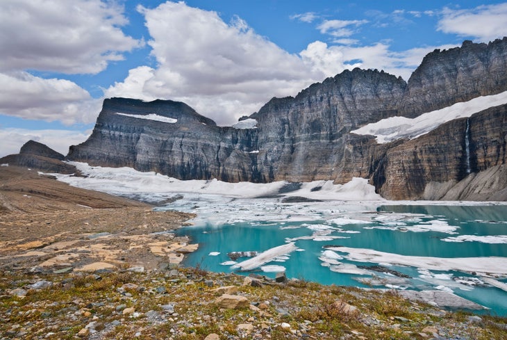 2014 photo of Grinnell Glacier from Upper Grinnell Lake with the Garden Wall in the background.