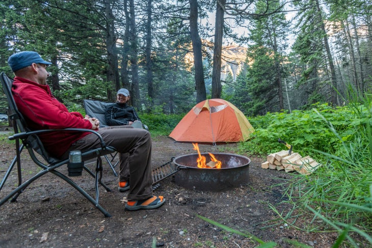 Enjoying a campfire in a campground fire ring in Glacier National Park