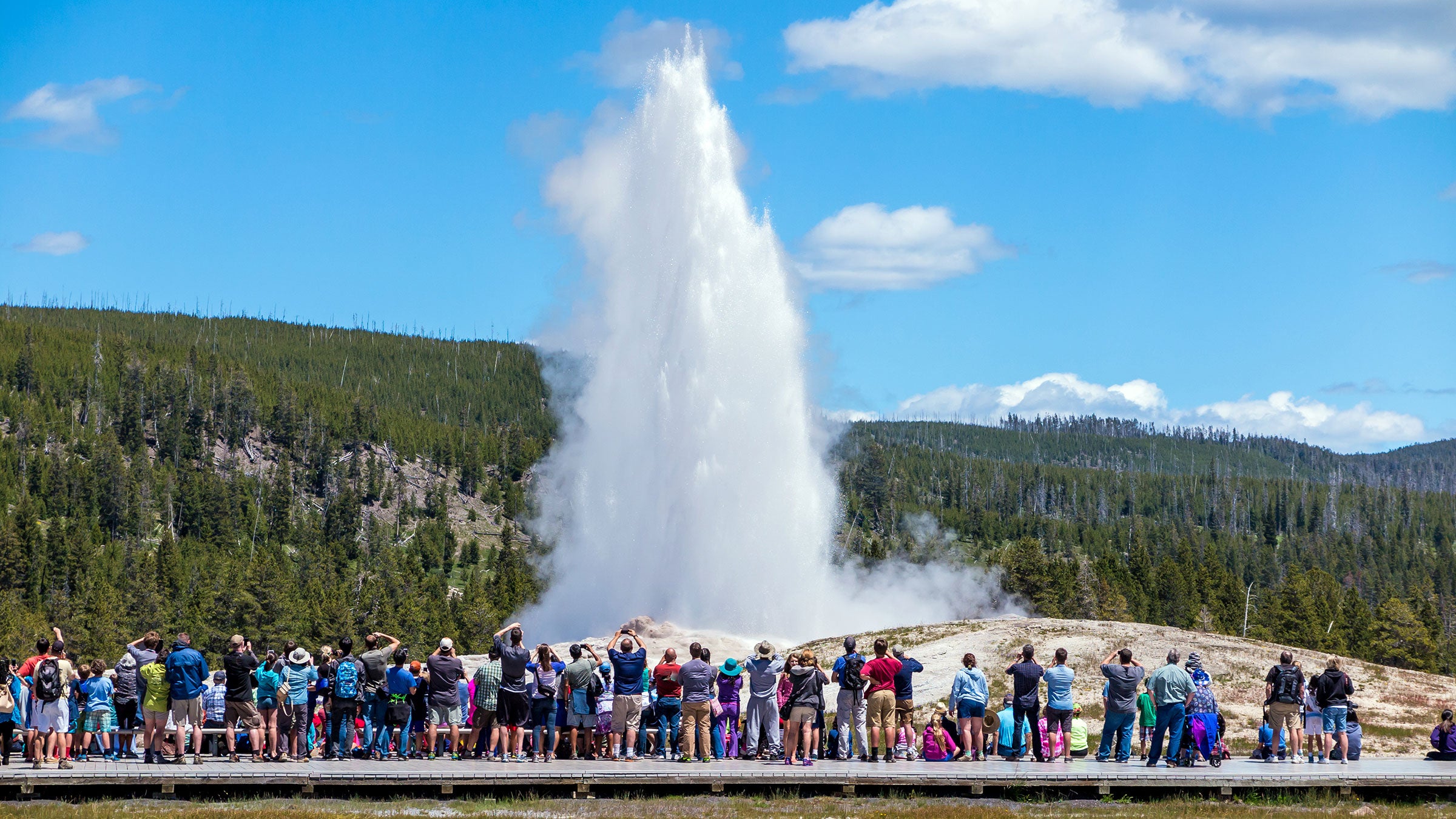 Crowd gathers to watch Old Faithful erupt in Yellowstone